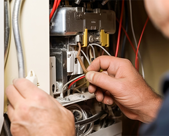 Person adjusting thermostat 