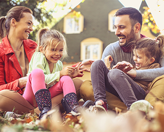 Happy family in front of house