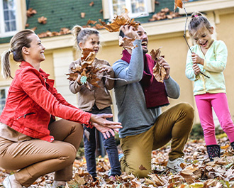 Happy family in front of house